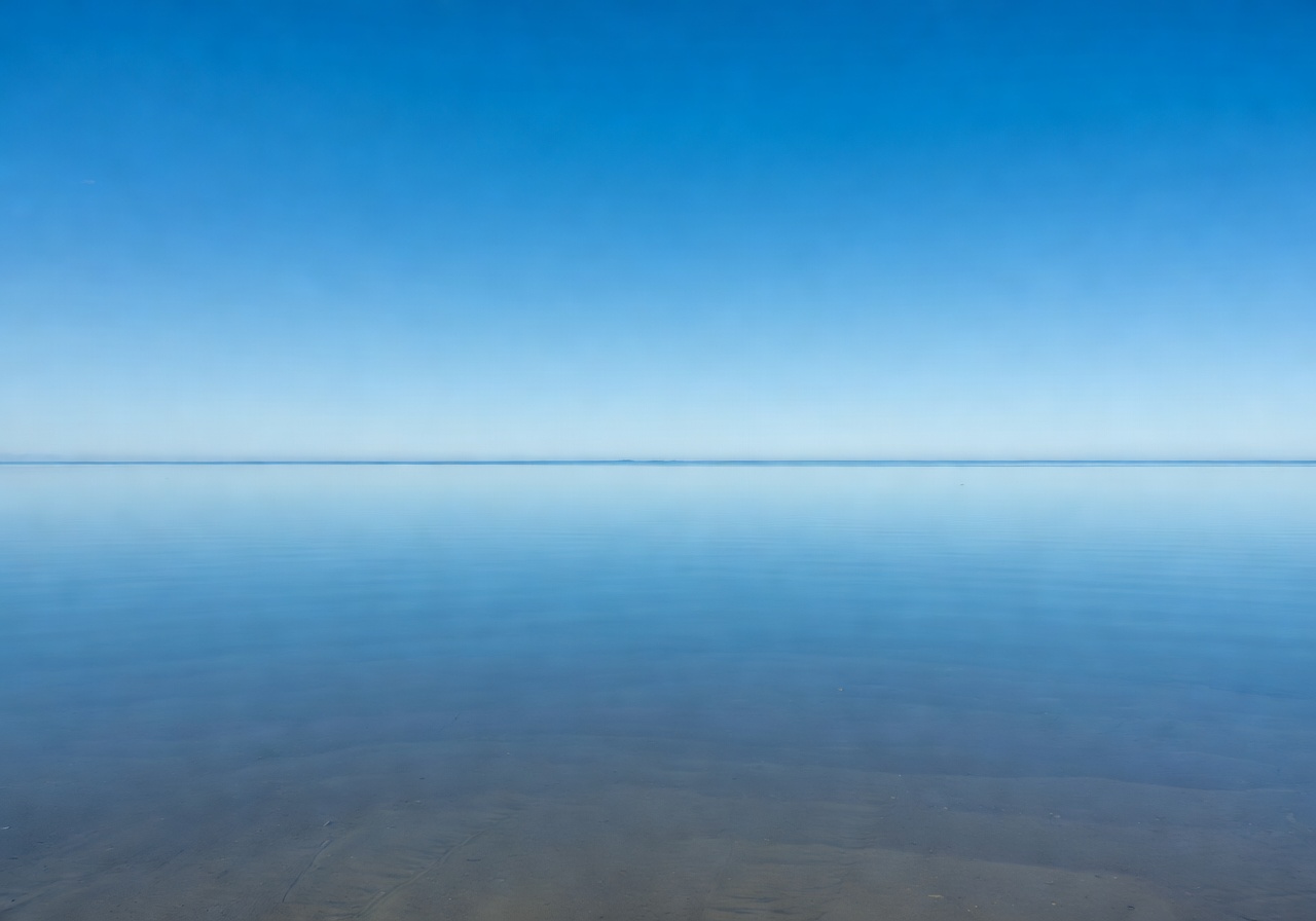 Calm pristine waters reflecting the clear sky